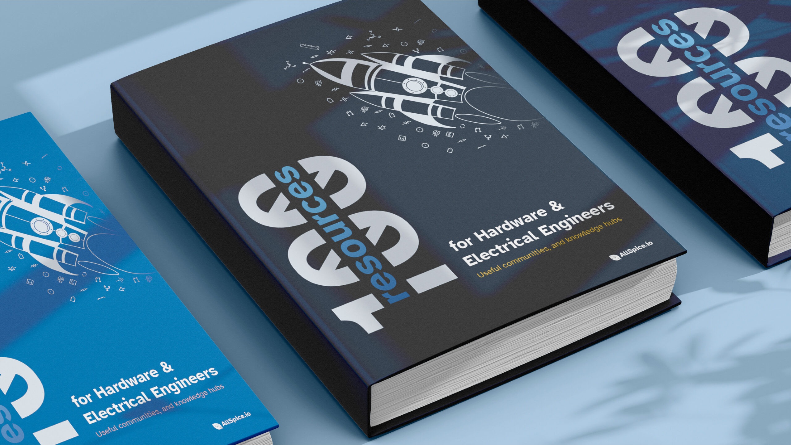 Three 100 Resources for hardware and electrical engineering books on a table